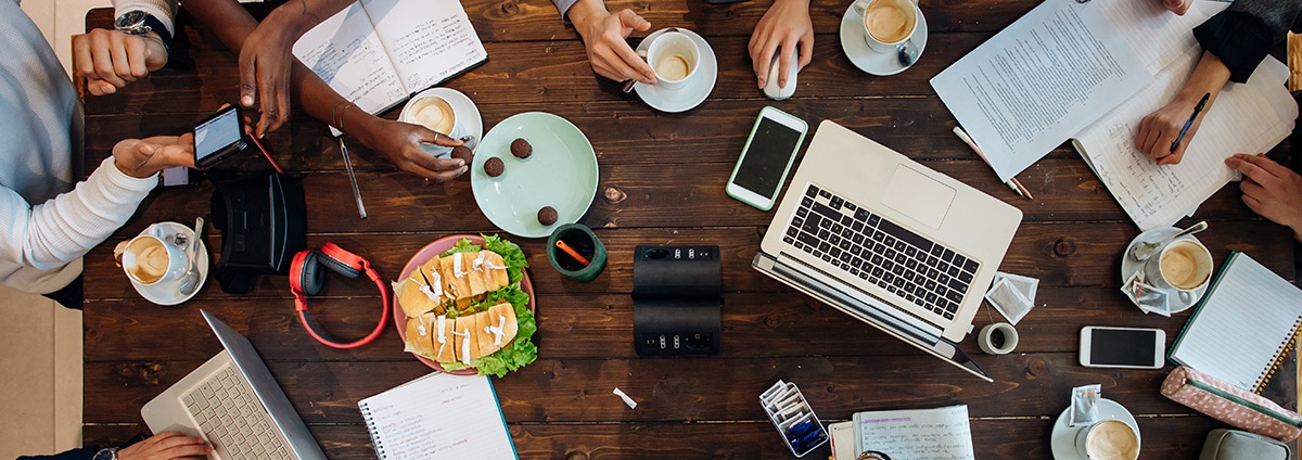 Business team meeting at cafe table