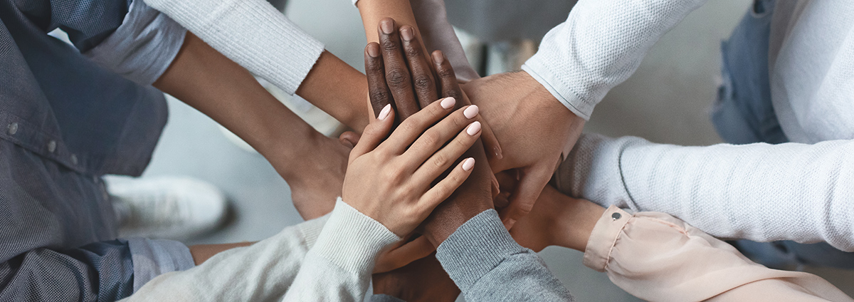 Business team putting hands together on top of each other